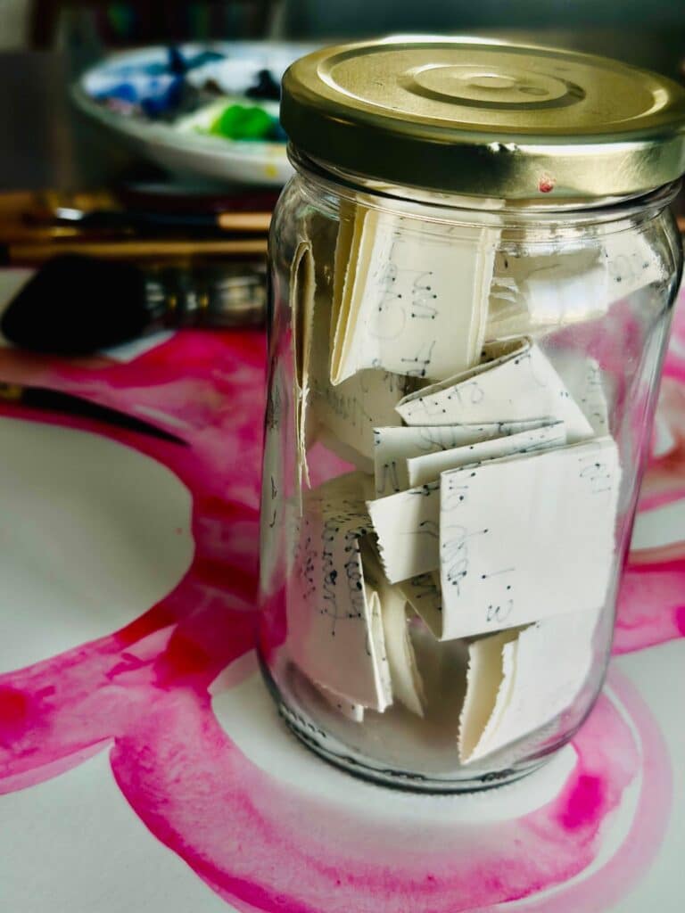 glass jar filled with slips of folded paper