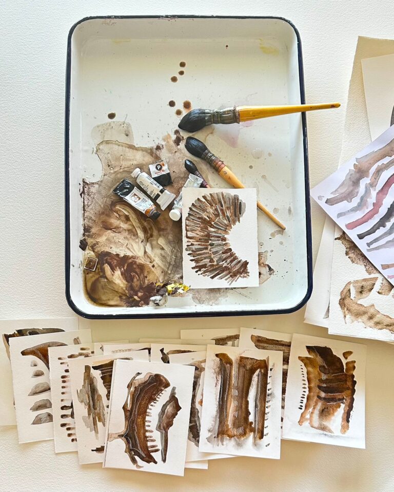 umber toned paintings by maureen claffy against a watercolor tray and paint tubes